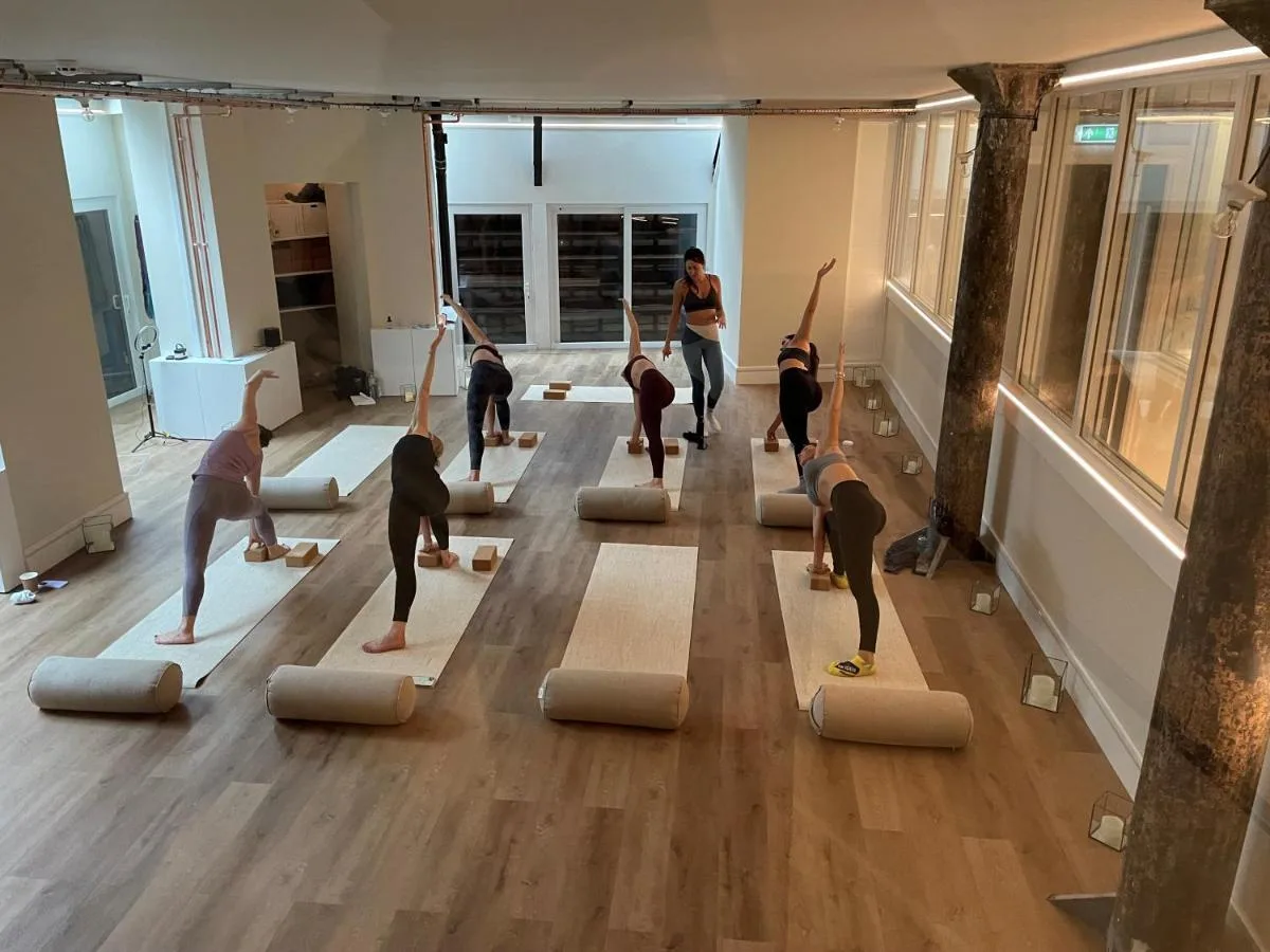 a group of people doing yoga in a room at The Harrington - Gloucester Road - 1 Harrington Gardens in London
